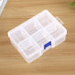 Clear plastic jewelry organizer with 6 divided slots and blue latch, covered lid