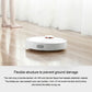 White robot vacuum on floor with visible orange main brush module