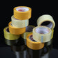 Stacked packing tape rolls in yellow and transparent white on a dark surface