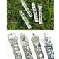 Set of silver metal bookmark rulers with decorative cutout patterns on green grass