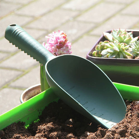 Dark green plastic mini soil shovel with wide scoop for potted plants