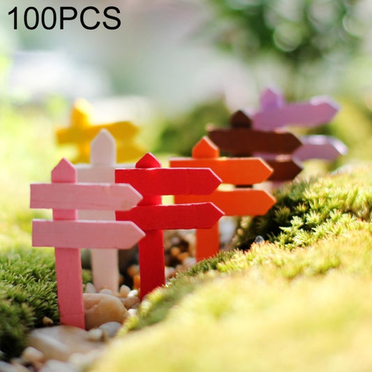 Mini wooden fence sign ornaments in assorted colors on artificial moss