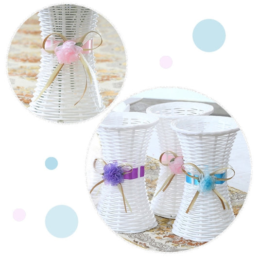 Set of white ribbon-tied flower vases with purple and blue bow decorations