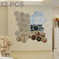 Hexagonal mirror wall sticker set, 12-pc 3D hex tiles in mixed colors on wall.