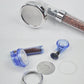 Shower head components: chrome head, blue caps, clear inserts, and filter beads