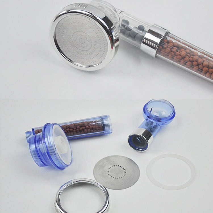 Shower head components: chrome head, blue caps, clear inserts, and filter beads