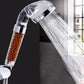 Chrome shower head spraying water; translucent filter chamber with beads is visible
