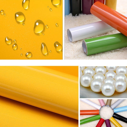 Pearlescent PVC wallpaper roll color samples in yellow, green, and orange with glossy finish