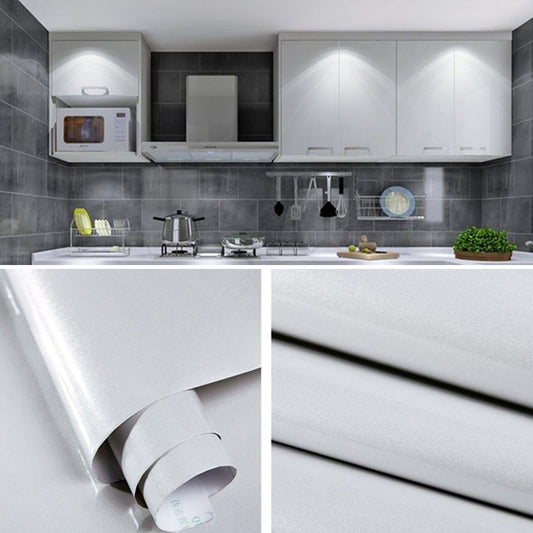 Pearlescent PVC wallpaper roll with metallic silver sheen, shown unrolled and curled