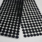 Close-up of black 10mm round nylon adhesive hook-and-loop fastener dots