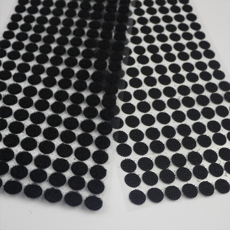 Close-up of black 10mm round nylon adhesive hook-and-loop fastener dots