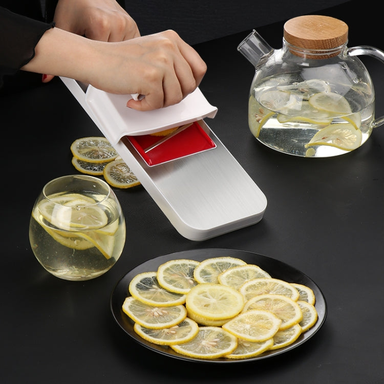 Stainless steel vegetable cutter with red slicing blade, shown with hands