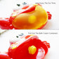 Red crab bath toy showing top spout and bubble cream container openings