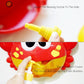 Red crab bath toy with yellow blowing nozzle attachment and foam bubble opening