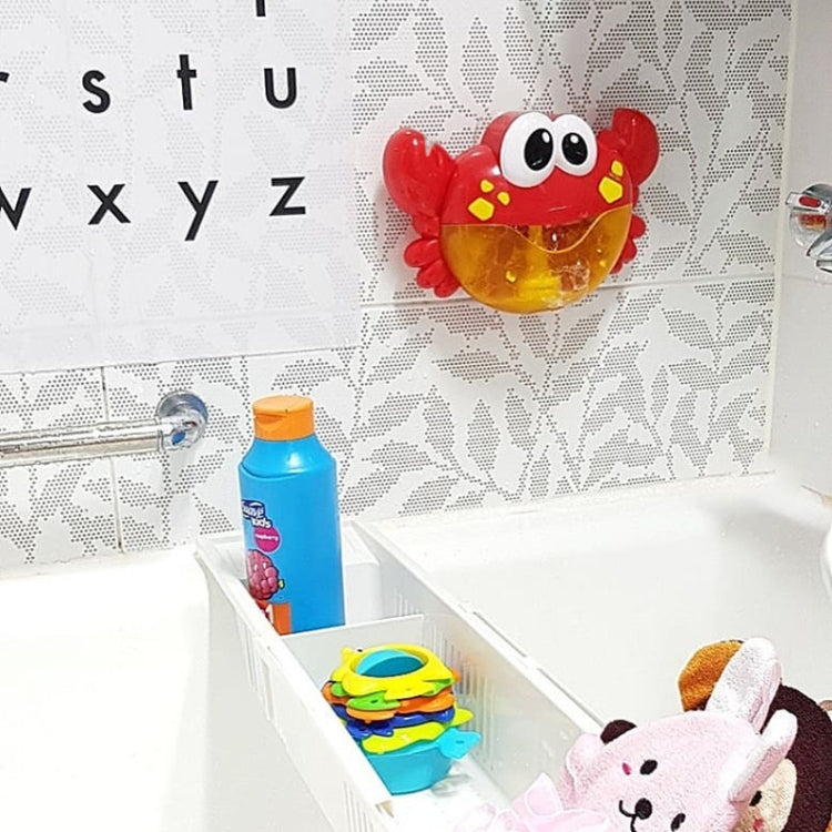 Red crab bubble bath toy wall-mounted on suction cup in a bathroom
