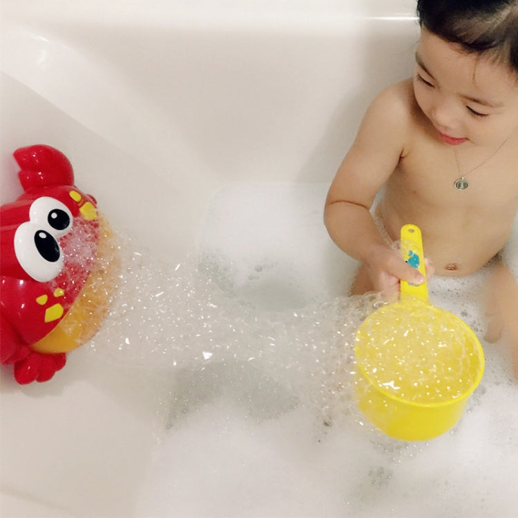 Red crab bubble bath toy with bubbling action beside a child in a bathtub