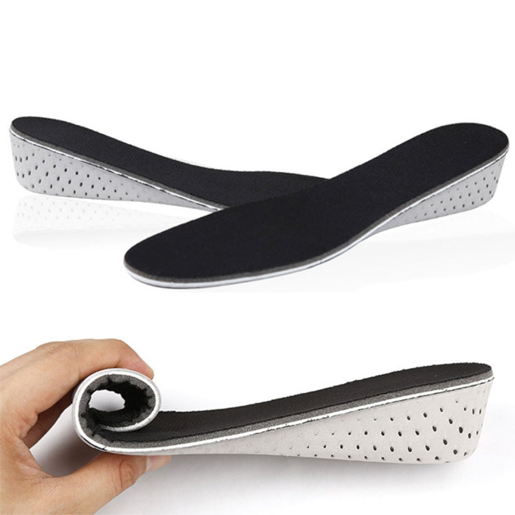 Black EVA insoles with breathable perforated underside; hand holds one, 3cm pair