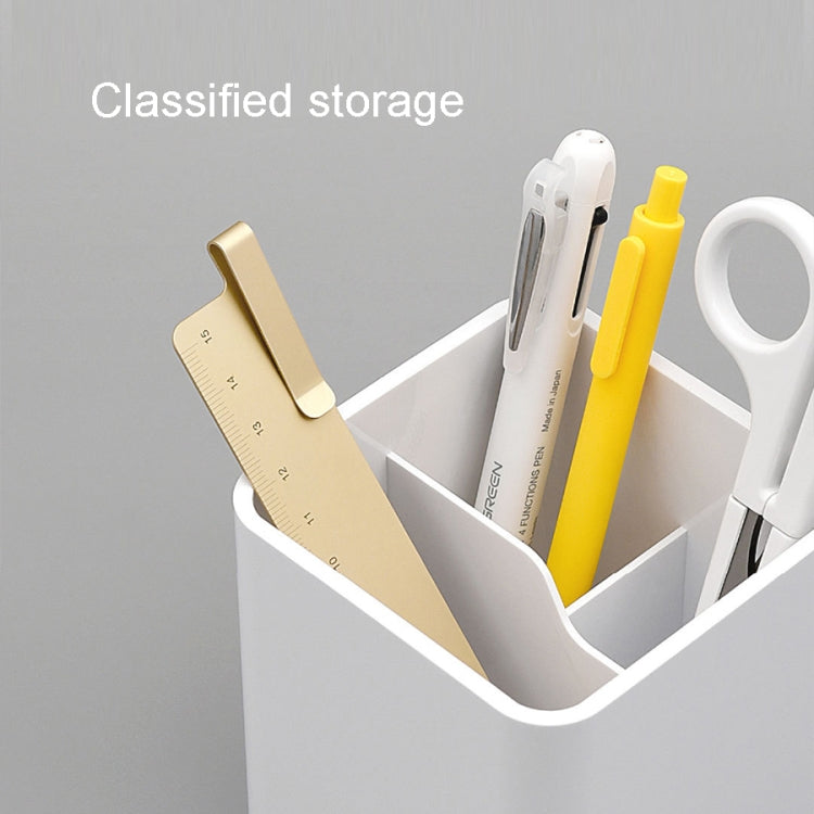 White desktop organizer box with compartments holding pens, scissors, and stationery