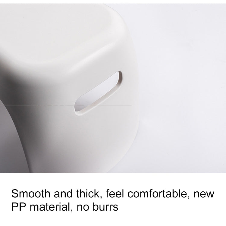 White plastic step stool side close-up with handle cutout grip