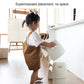 White plastic step stool in use by a child near a countertop