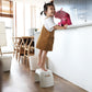 White plastic step stool with side cutout handle used for safe climbing