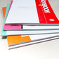 Stacked A5 soft cover diaries with colored spines, shown in close-up
