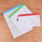 Reusable mesh food pouches with drawstring ties, white with blue and green trim