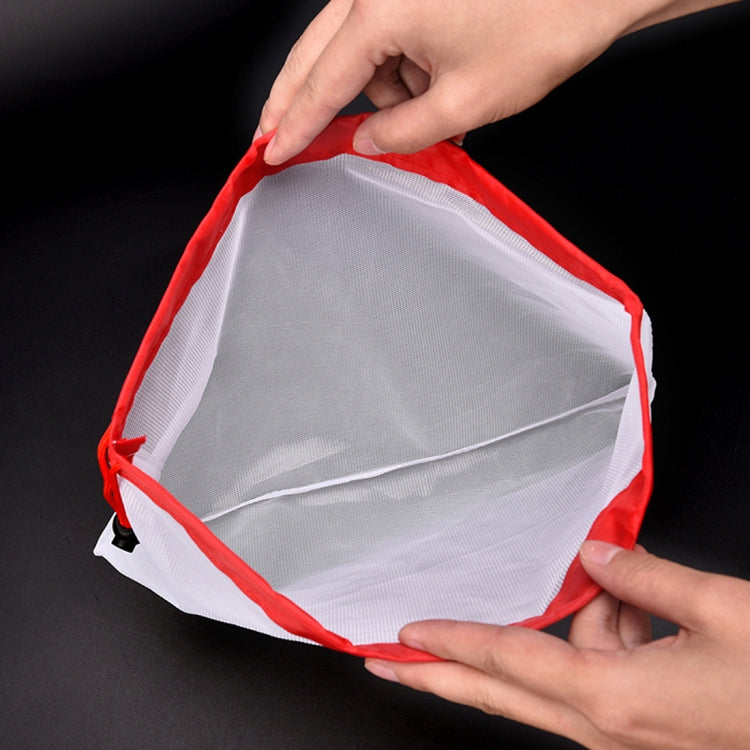 Red-trim reusable mesh food pouch with drawstring closure, held open by hands