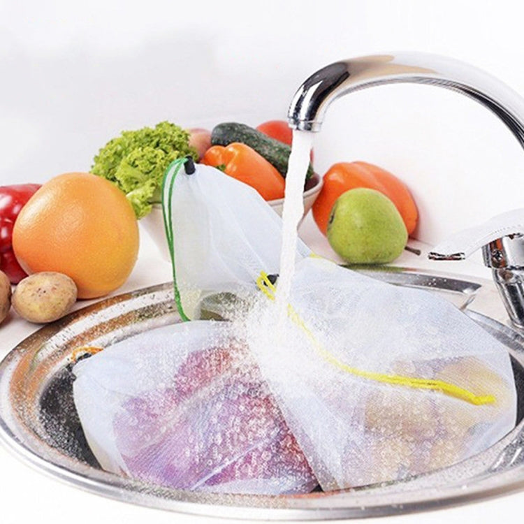 Reusable mesh food pouch with drawstring tie, partially filled with produce and water