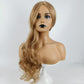 Long blonde wavy curly wig on mannequin with side part