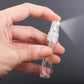 Close-up of clear 5ml perfume spray bottle held in hand