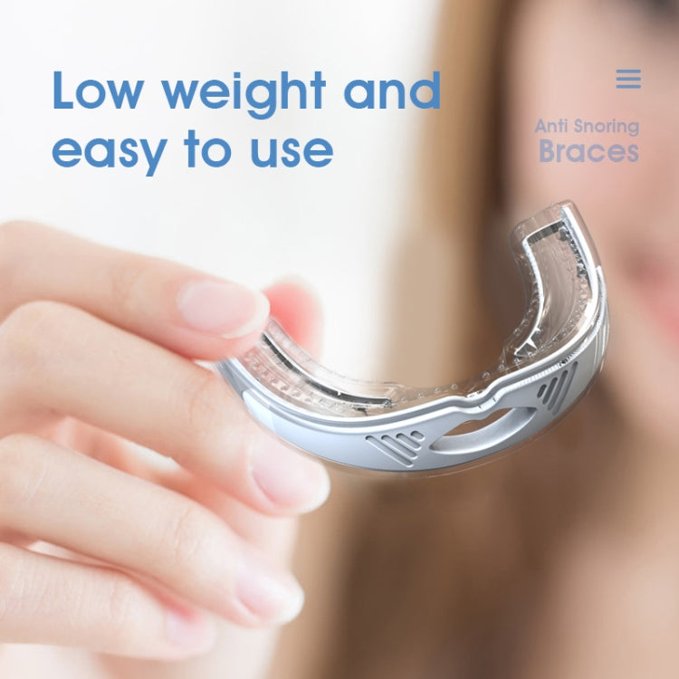 White anti-snoring mouth brace held in hand, showing curved bite area
