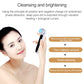 Silver handheld facial massager with blue LED head held near face