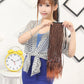 Dark brown ponytail hair extension worn by model, with two straps and multicolor thread accents