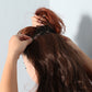 Clip-in long hair wig piece positioned near the crown, dark auburn shade