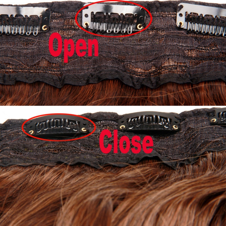 Wig base close-up with adjustable metal comb clips in an open position