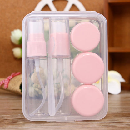 Travel size cosmetics bottle kit, clear case with pink caps and small travel bottles