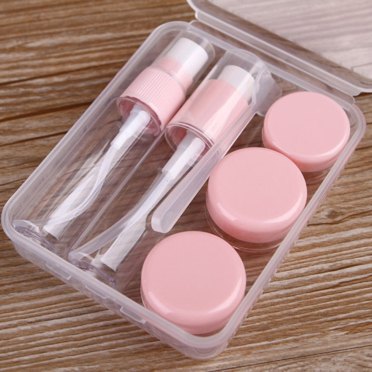 Travel size cosmetics bottle kit with three pink squeeze caps and clear squeeze tubes