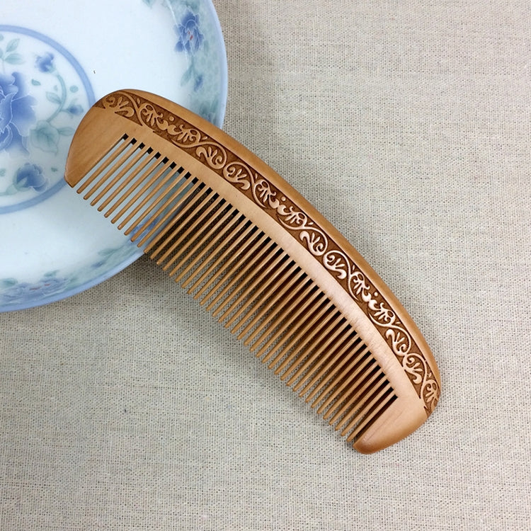Brown wooden anti-static massage comb with carved floral border and fine teeth