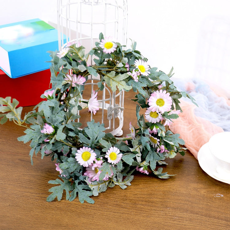 Artificial flower vine with light pink daisy blossoms and green leafy stems