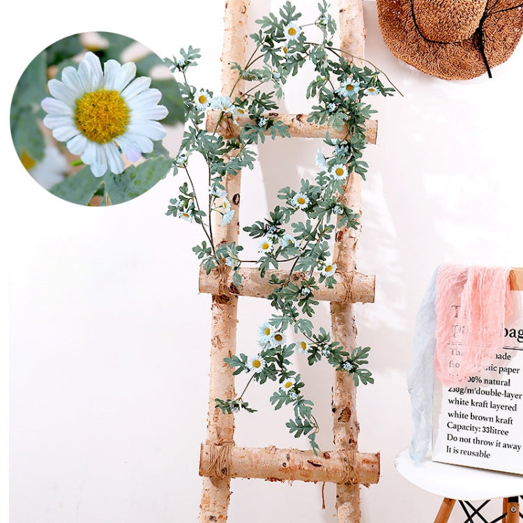 Artificial flower vine with white daisy blossoms and green leaves on a birch-style frame