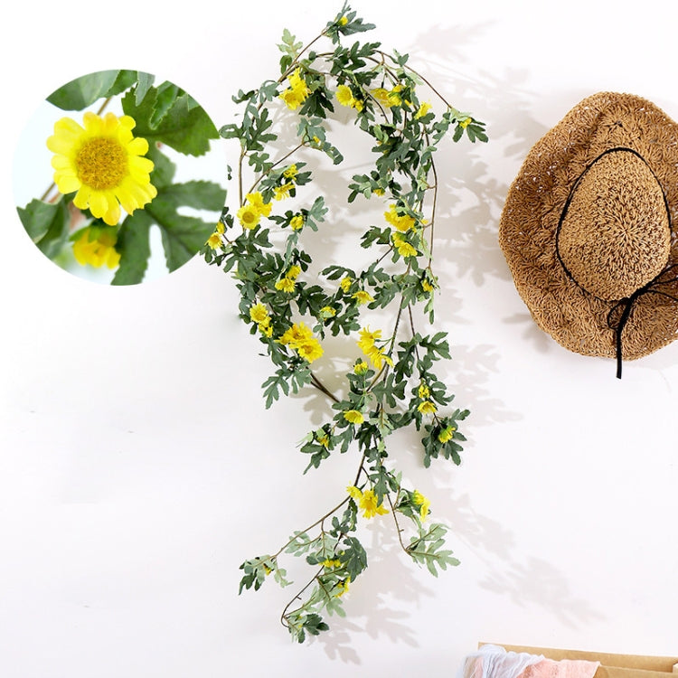 Artificial flower vine with yellow daisy blossoms and green leaves, decorative hanging vine
