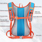Blue hydration backpack with orange straps, buckles, whistle detail, and breathable mesh backing