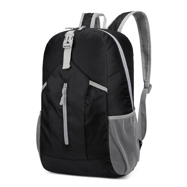 Black foldable hiking backpack with front zip pocket, top handle, and mesh side panels