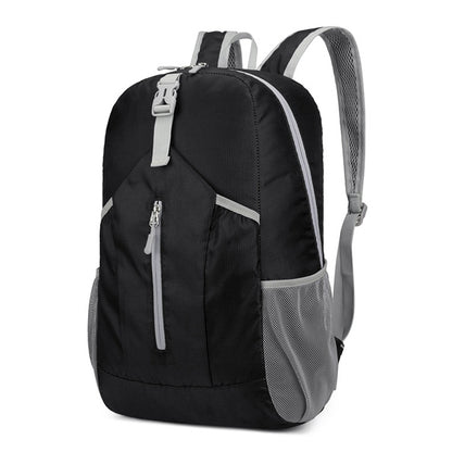Black foldable hiking backpack with front zip pocket, top handle, and mesh side panels