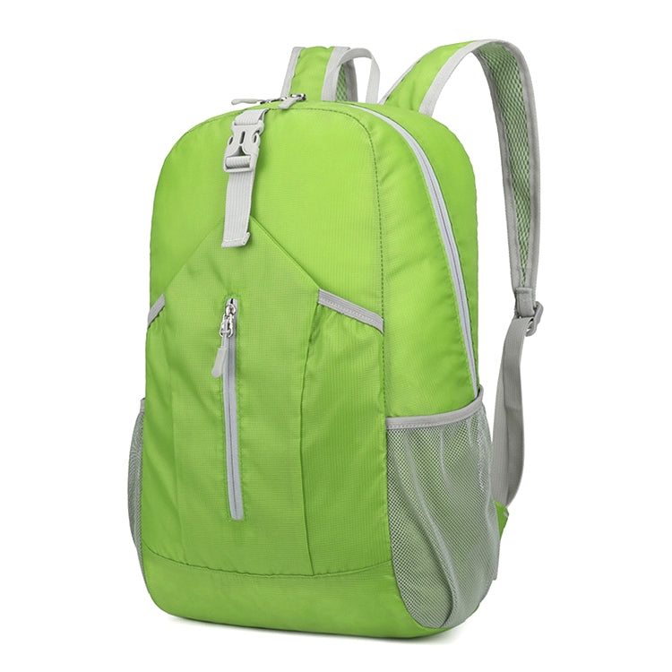 Green foldable hiking backpack with front zip pocket, top handle, and mesh side panels