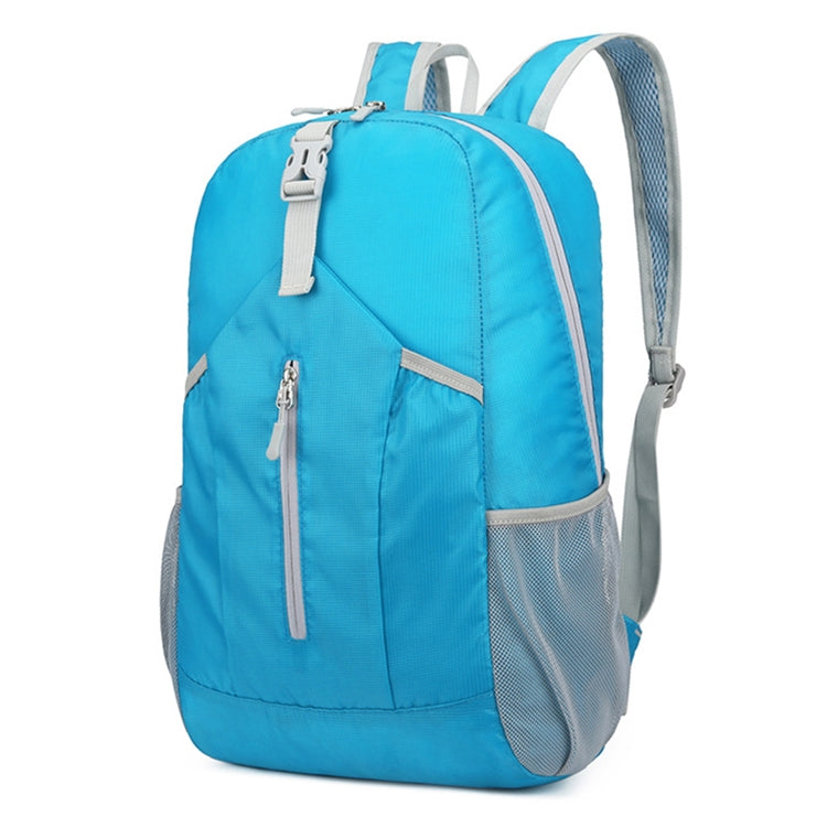 Blue foldable hiking backpack with front zip pocket, top handle, and mesh side panels