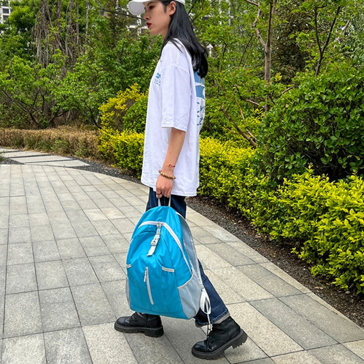 Foldable hiking backpack, light blue with open interior and top zipper