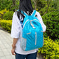 Large capacity hiking backpack in light blue with front zip pocket and padded straps