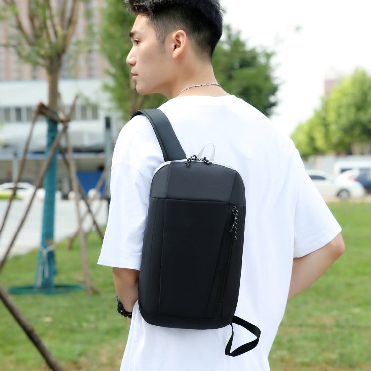 Black backpack worn on back with adjustable straps and front top zipper
